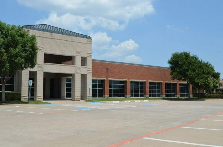 Exterior view of the brick facade at 5055 W. Park Blvd, Suite 400.