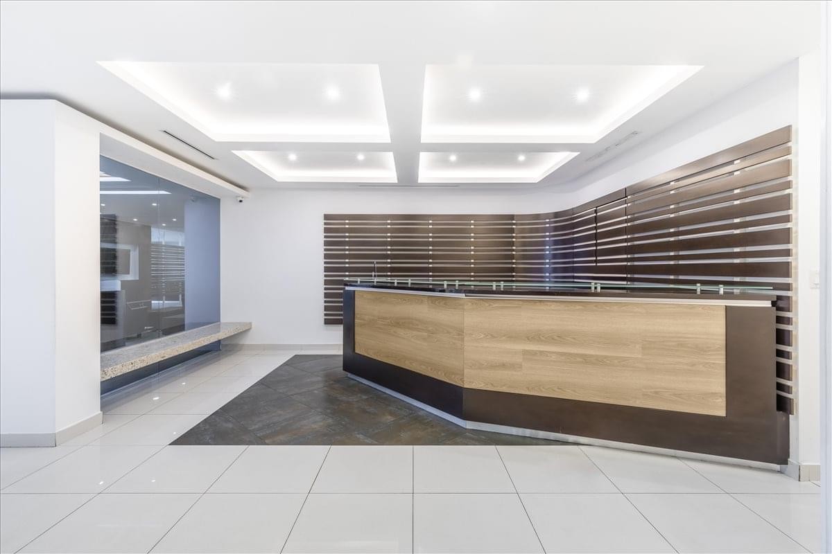 Reception area at the Tower Financial Center featuring a large wood and charcoal desk.
