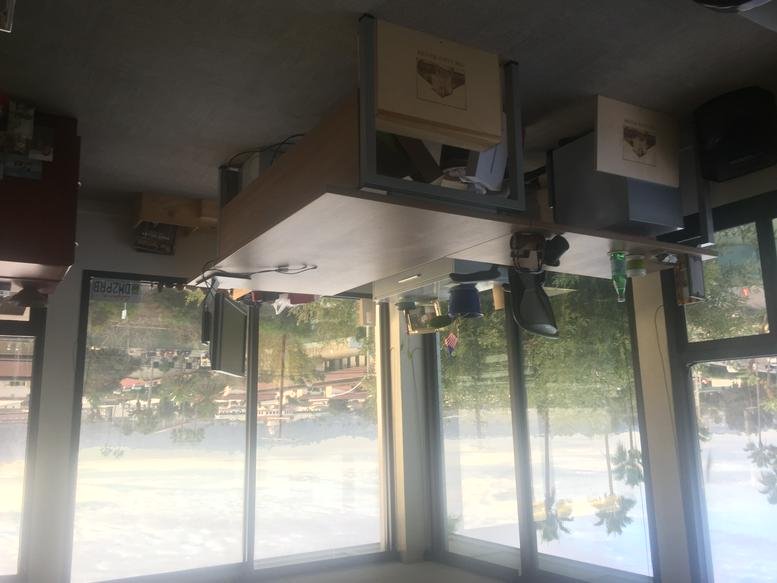 Inverted view of a sunlit office area with glass walls overlooking the surrounding neighborhood.