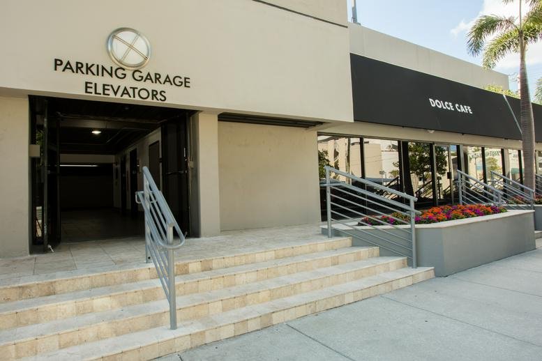 Building entrance at 515 North Flagler Drive with a stone staircase and signage.