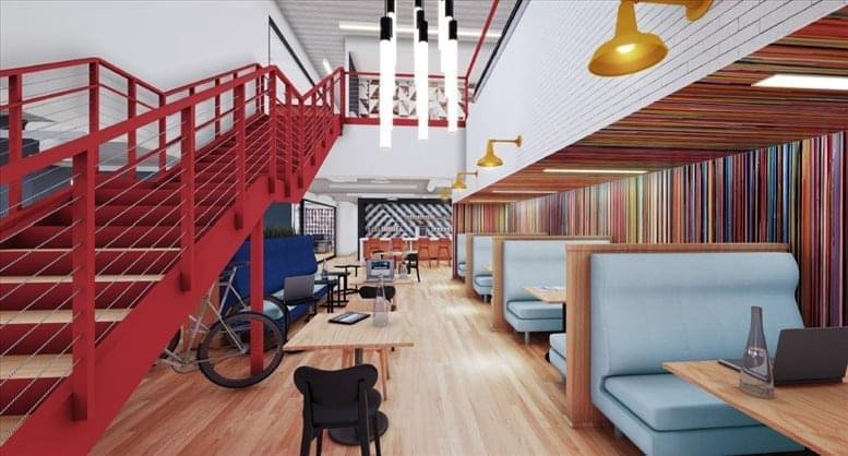 Spacious communal lounge at Paul Hastings Tower, 515 South Flower St, featuring a red staircase and booth seating.