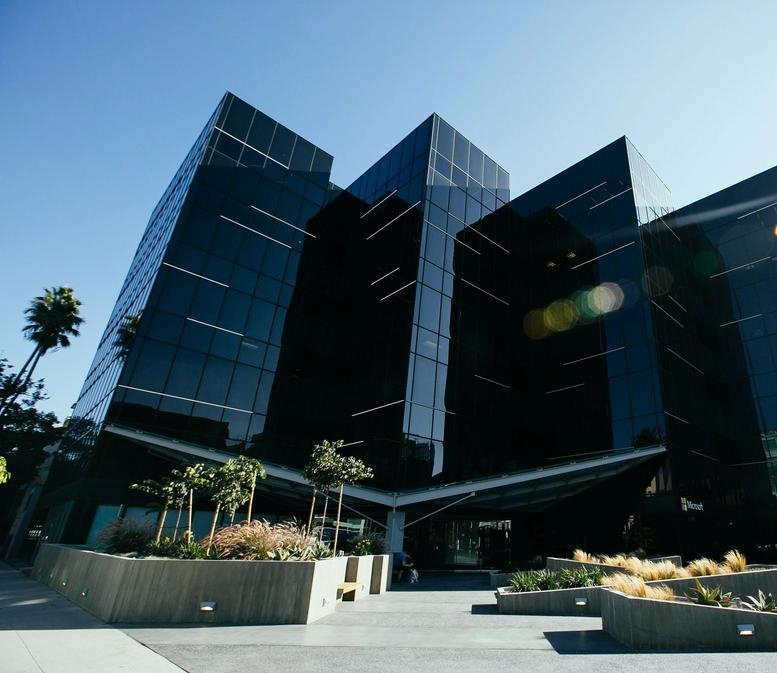 Angular black glass facade of the modern office building at 520 Broadway.