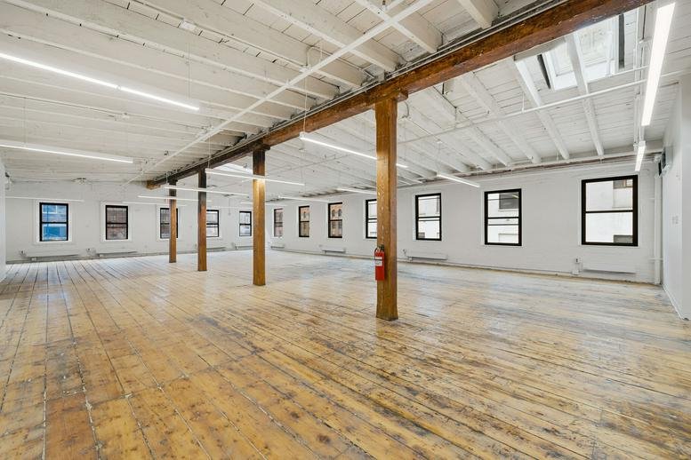 Expansive industrial loft workspace at 53 Pearl Street, Dumbo, Brooklyn, New York with timber columns.