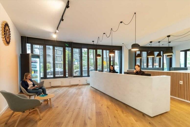Reception area at 530 Technology Drive, Suite 100 & 200 featuring a white desk and warm wooden floors.