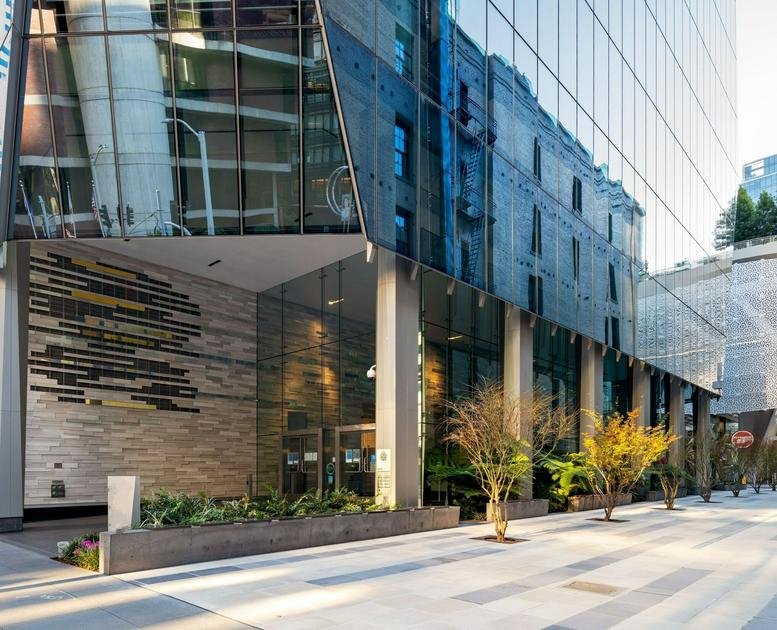 Exterior view of the modern glass-facade building at 535 Mission St.