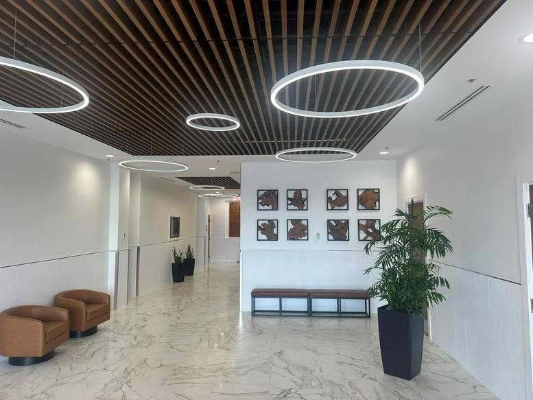 Spacious lobby of the Regions Bank Building, Kirkman Road, Orlando with wood slat ceilings and circular lights.