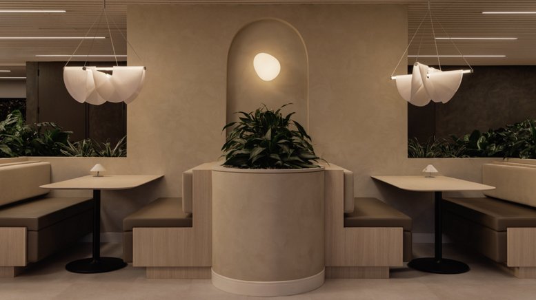 Symmetrical booth seating area with arched wall niche and decorative sculptural lighting.