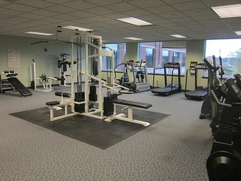The bright fitness center at 550 Cochituate Rd, East Wing, Floor 4, Suite 25 with various workout machines.