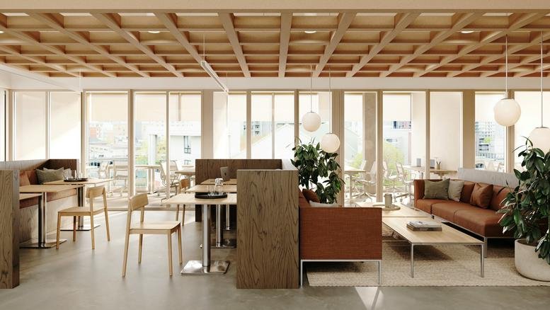 Stylish break area with mid-century modern furniture and warm wood finishes.