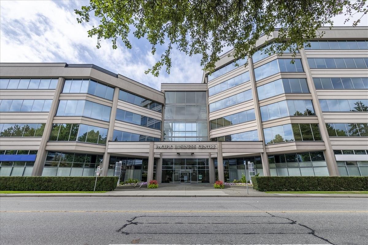 Exterior view of the Richmond Business Centre at 5811 Cooney Road showing the modern glass facade.