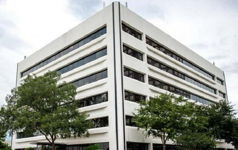 Exterior view of the white tiered-facade building at 5850 San Felipe.