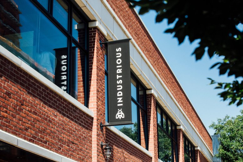 Exterior brick facade of Industrious at Brooklyn - 594 Dean, Prospect Park, New York City with black banners.