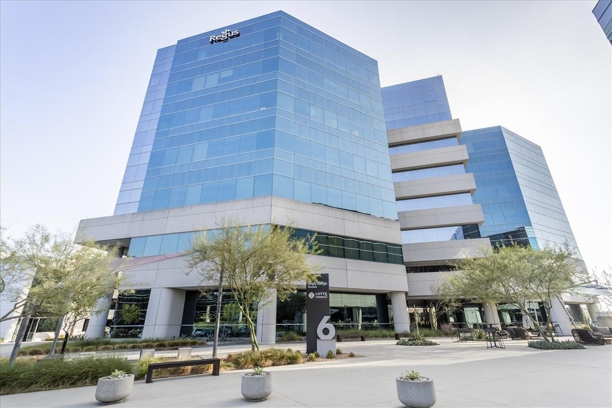 Exterior view of the blue glass office tower at 6 Centerpointe Drive, Suite 700.