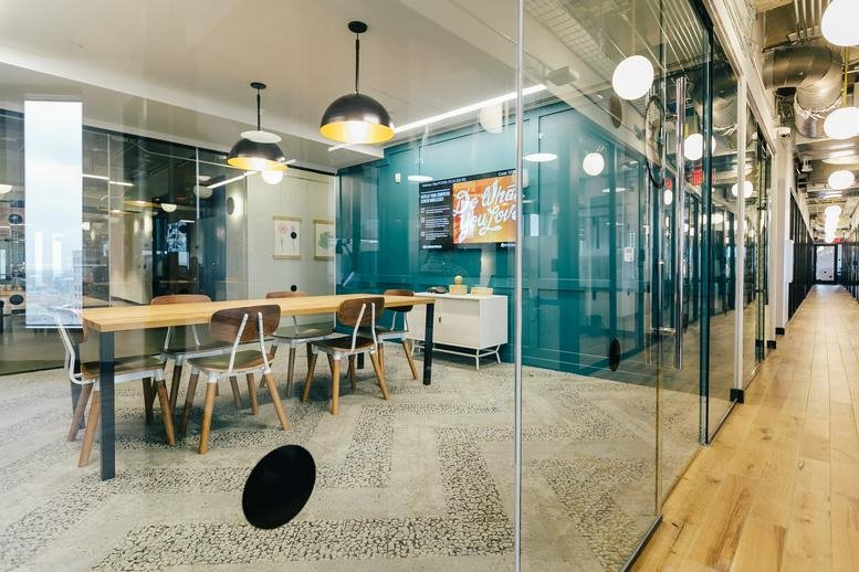 Spacious meeting room at 14th Floor, 600 Congress Avenue with pendant lights and teal glass walls.