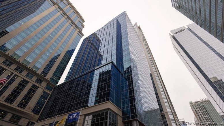Upward exterior view of the glass facade of Legacy Union at 600 S Tryon Street.