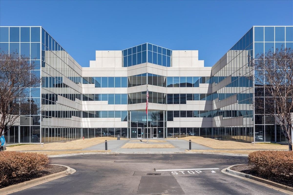 Symmetrical glass facade exterior of the 6000 Poplar Avenue, Suite 250 building.