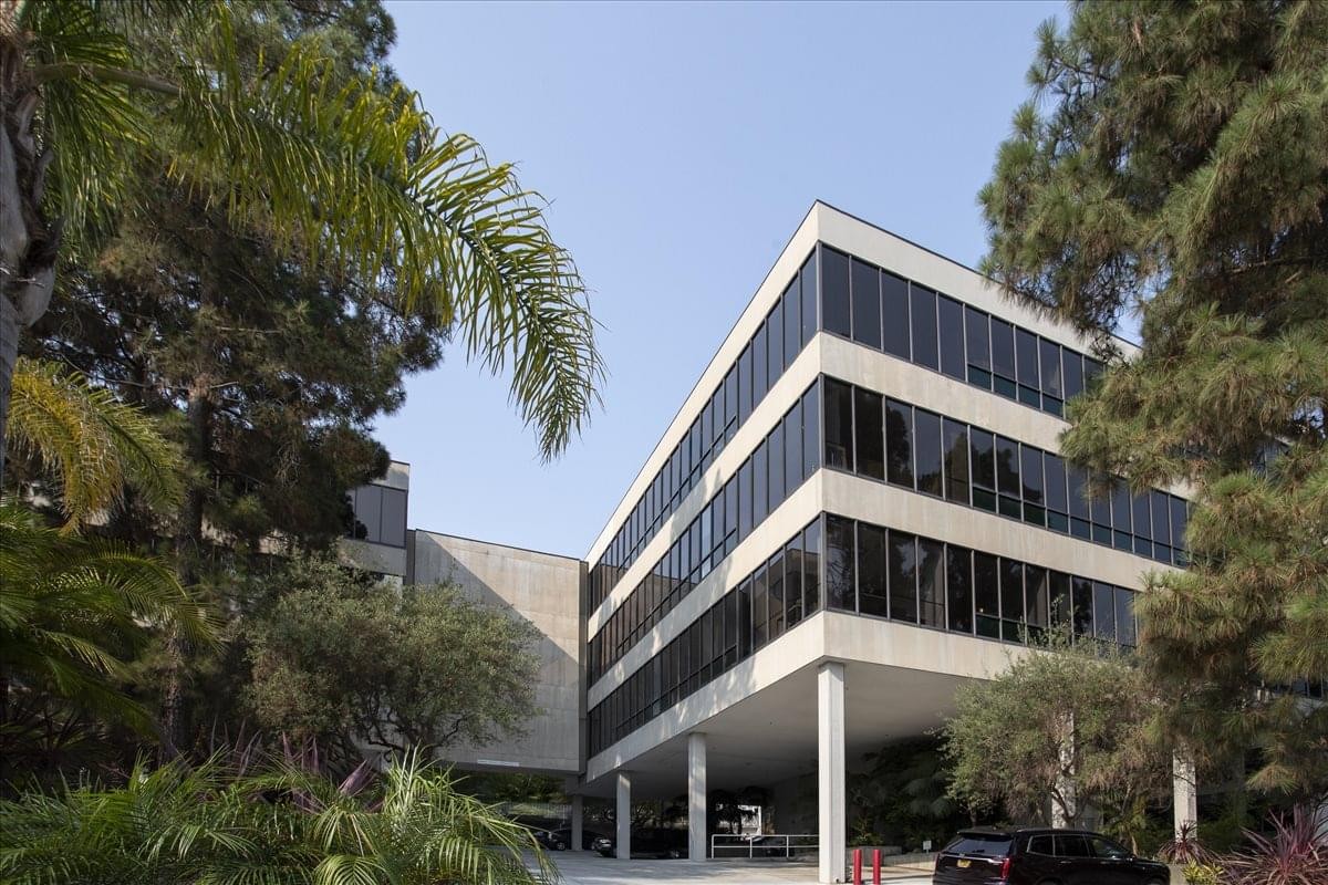 Exterior view of the tiered white and glass building at 609 Deep Valley Drive.