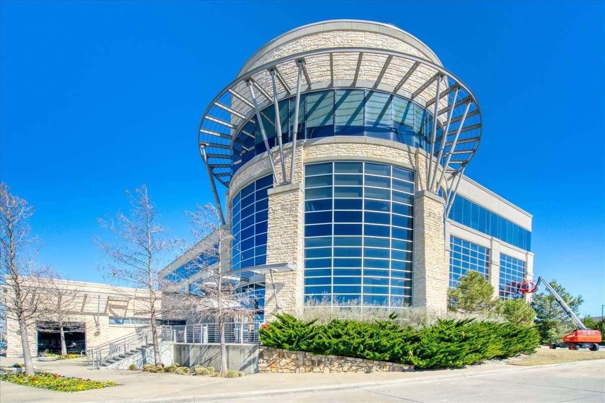 Exterior view of the modern stone and glass facade building at 610 Uptown.