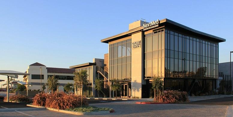 Exterior view of the modern glass and stone facade at NextMed Center.