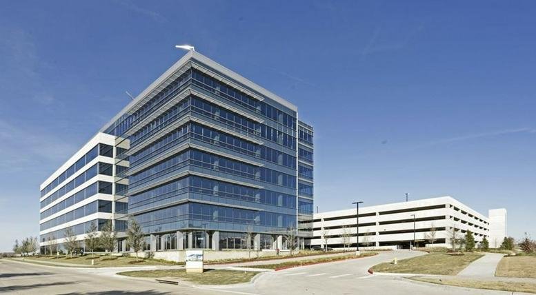 Exterior facade of the modern glass office building at 6160 Warren Parkway.