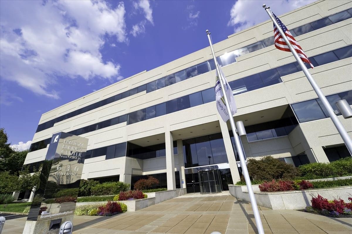 Modern stone facade of the 630 Freedom Business Center, King Of Prussia Center with manicured landscaping.