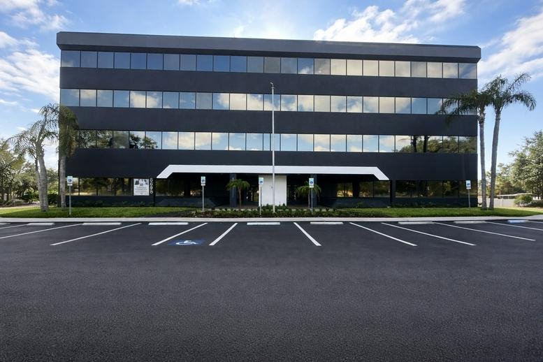 Exterior view of the dark facade office building at 6698 68th Avenue North.