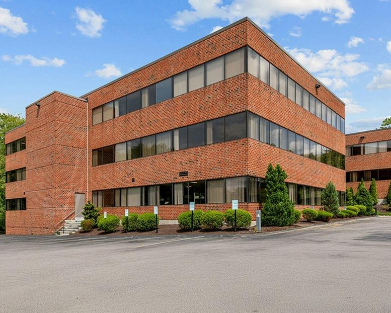 Brick exterior of the three-story office building at 67 Forest Street.