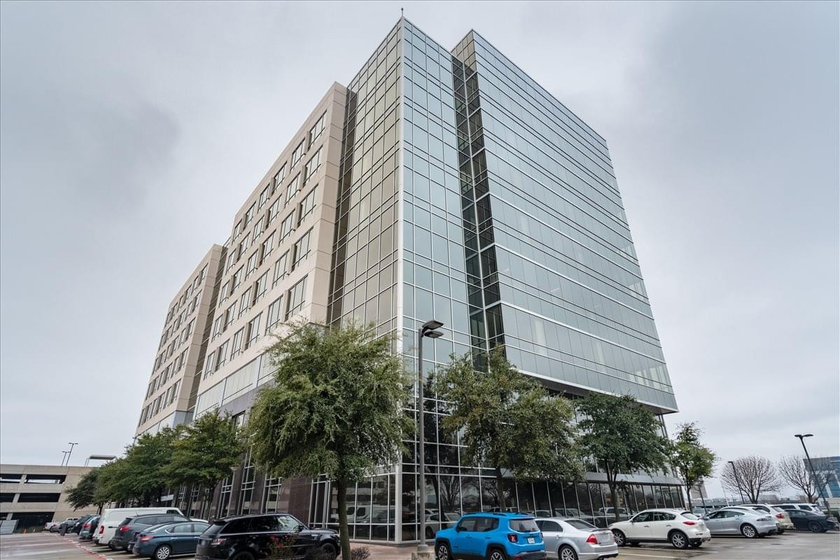 Modern multi-story exterior facade of the office building at 6860 N Dallas Parkway.