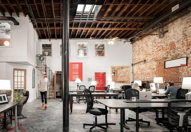 Spacious industrial-style workspace at 691 John Wesley Dobbs Avenue Northeast with exposed brick and high ceilings.