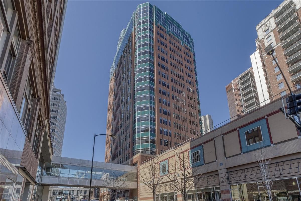 Exterior view of the tall brown and glass facade building at 699 Walnut Street.