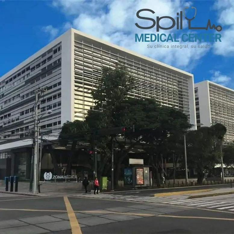 Modern multi-story exterior facade of the Spil Medical Center under a bright blue sky.