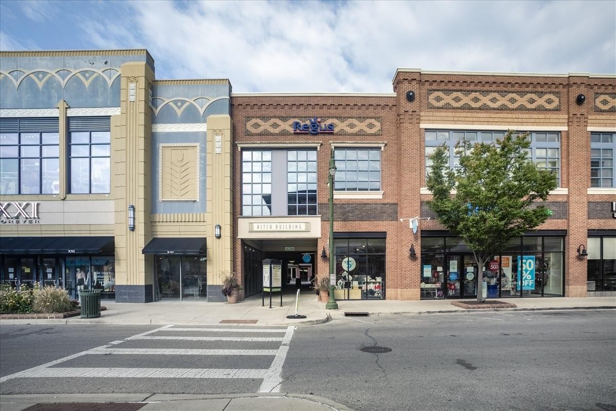 Street view of the building facade with three storefronts.