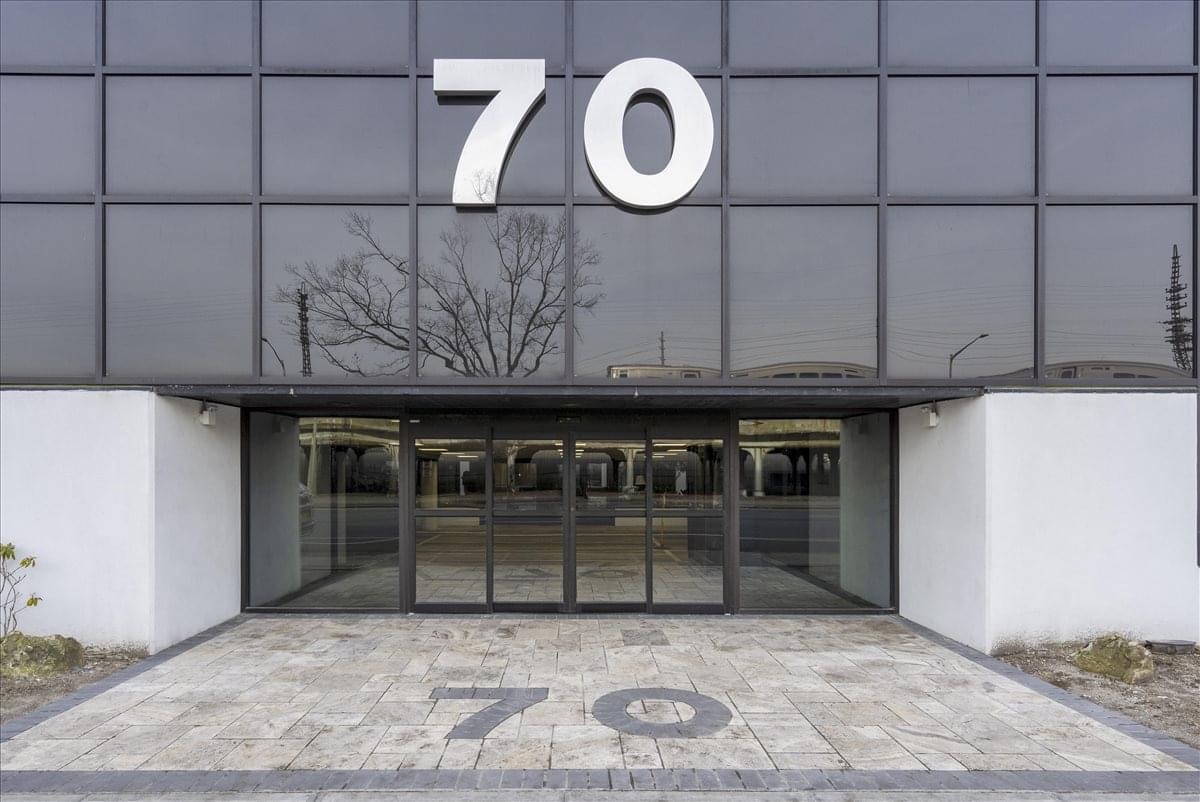 Glass entrance of the building at 70 East Sunrise Highway, Suite 500.