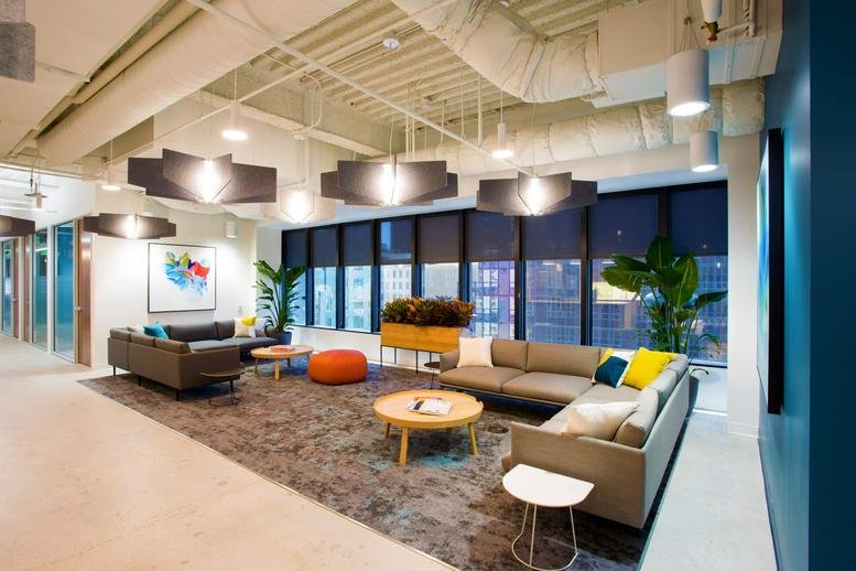 Spacious communal lounge at 700 S Flower Street, Suite 1000 with modern furniture and city views.