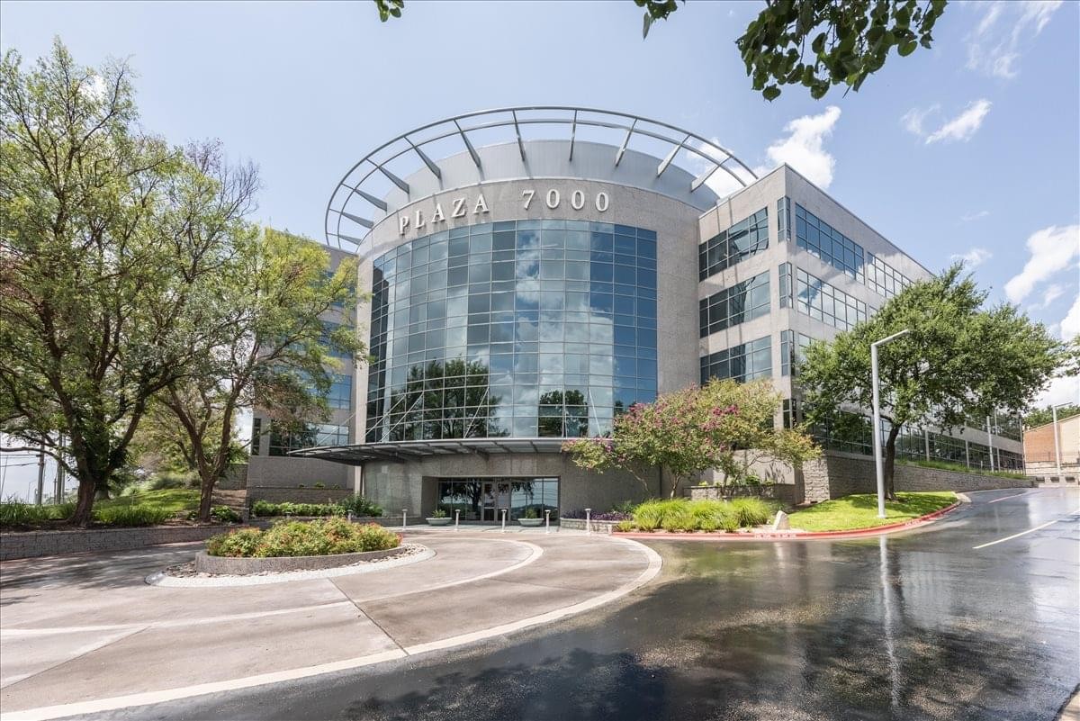 Exterior view of the curved glass facade at the Plaza 7000 building.