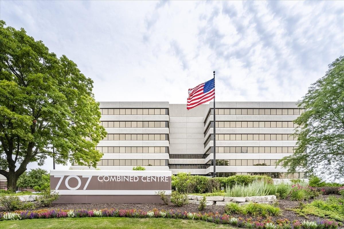 Exterior view of the multi-story 707 Skokie Boulevard Center with an American flag.