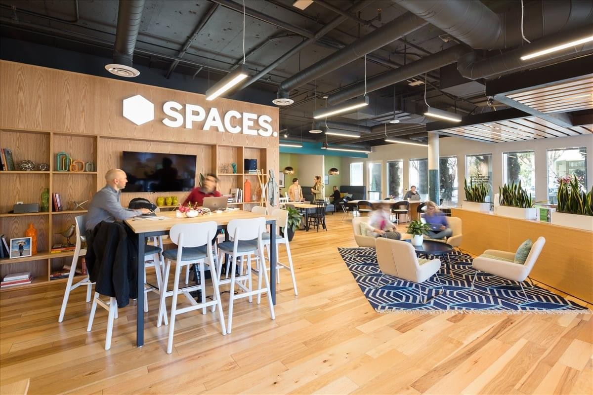 Vibrant communal lounge at Spaces Santa Monica, Silicon Beach featuring light wood floors and modern decor.