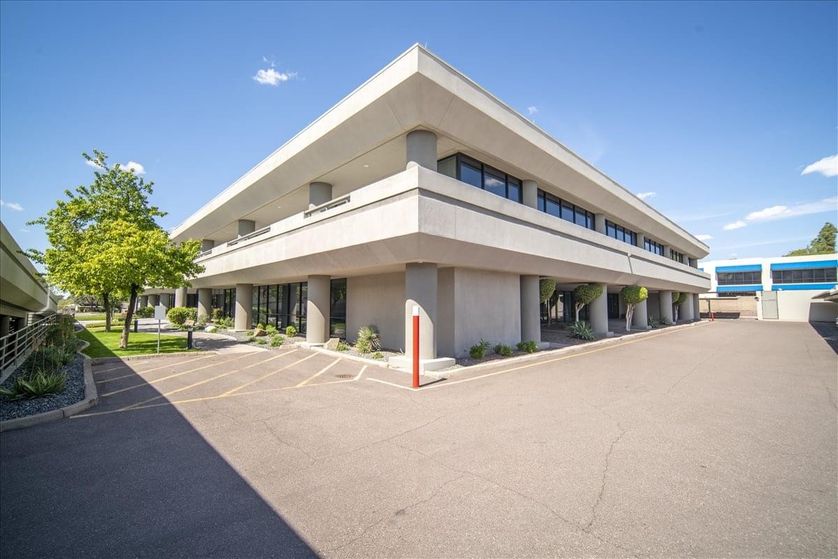 Exterior view of the white facade and multi-level structure of The Peak at 7301 North 16th Street.