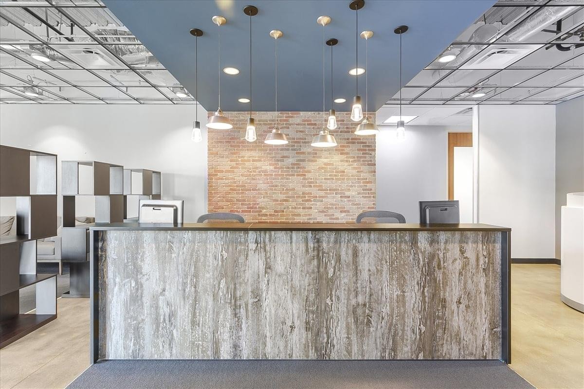 Reception area at Stonebriar Center featuring a stone feature wall and modern pendant lighting.