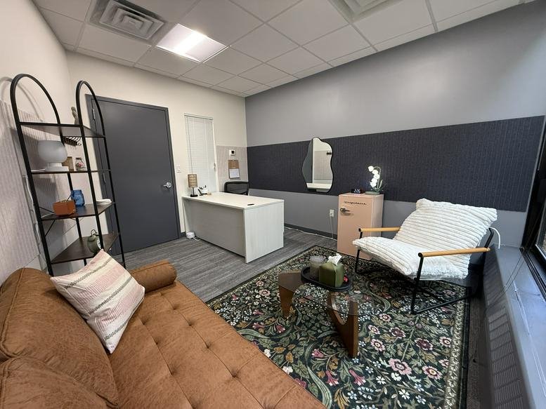 Spacious private office with a brown leather sofa and desk at Virginia Road Professional Building, White Plains.