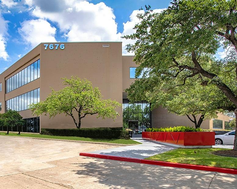 Exterior view of the multi-story office building at 7676 Hillmont, Houston, Texas with manicured landscaping.