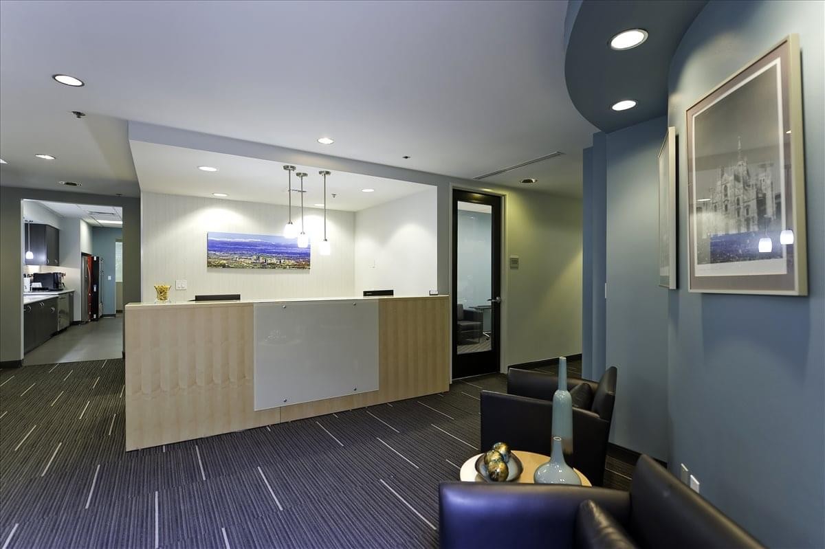 Bright reception desk at Campus Commons Center with wood paneling and blue accent walls.