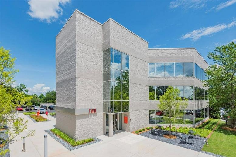 Exterior view of the modern stone and glass building at 777 Lowndes Hill Road.