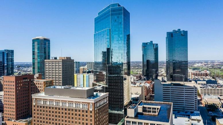 Wide-angle view of the city skyline with modern glass skyscrapers.