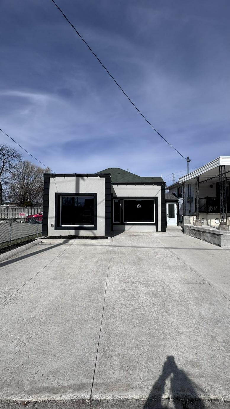 Exterior view of the white and black facade of 8 Water Street, Streetsville.