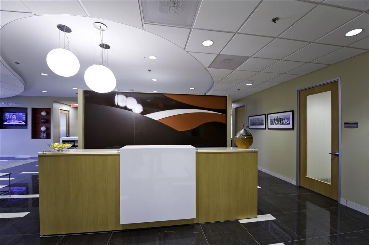Professional reception desk at 800 Corporate Drive, 3rd Floor featuring warm wood and modern lighting.