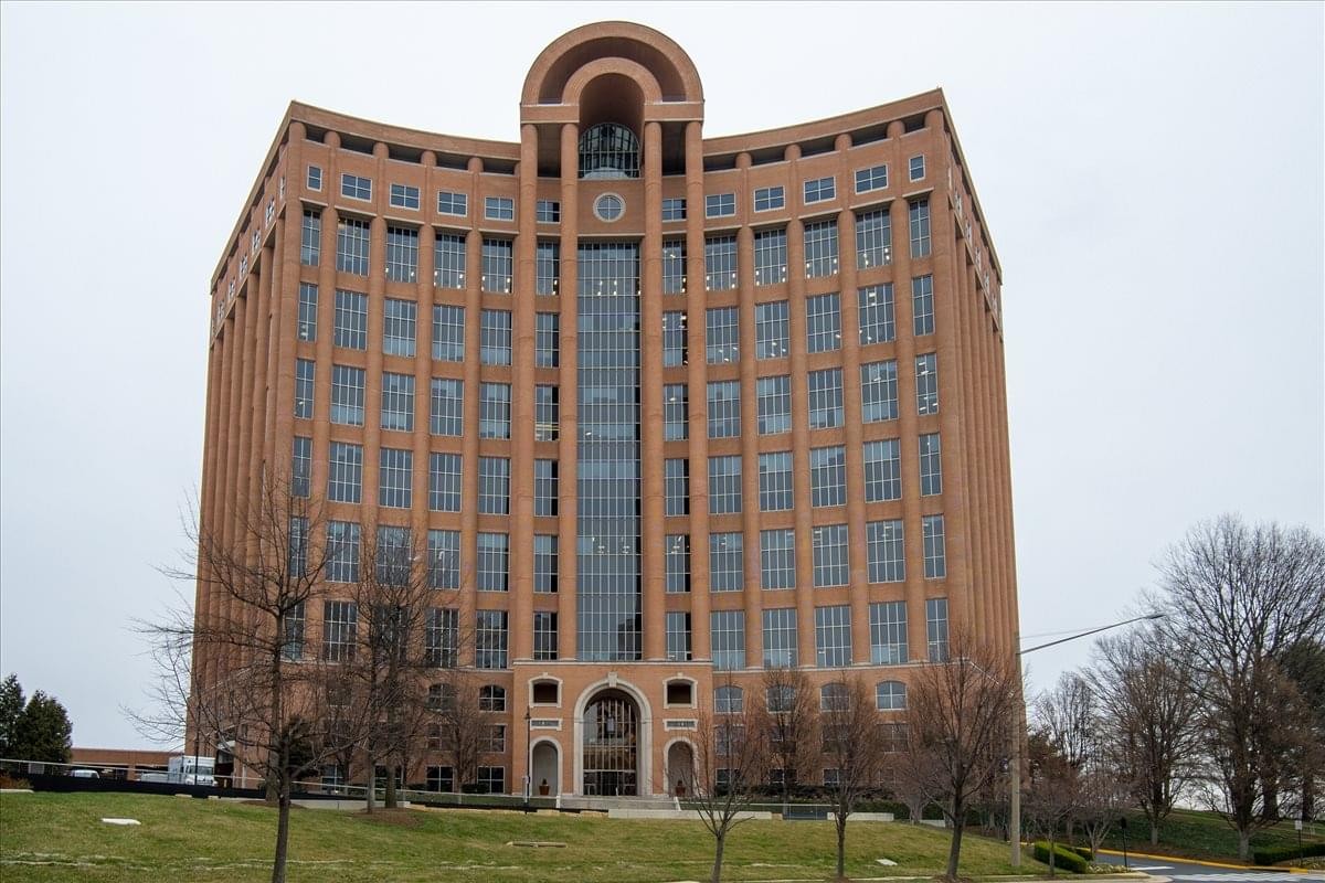Exterior view of the red brick facade and arched central tower at Towers Crescent Centre.