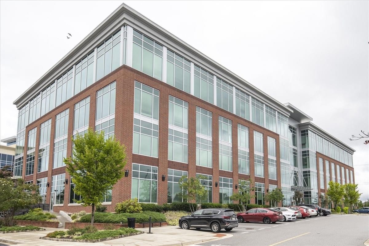 Exterior view of the brick and glass facade of 8115 Maple Lawn Boulevard.