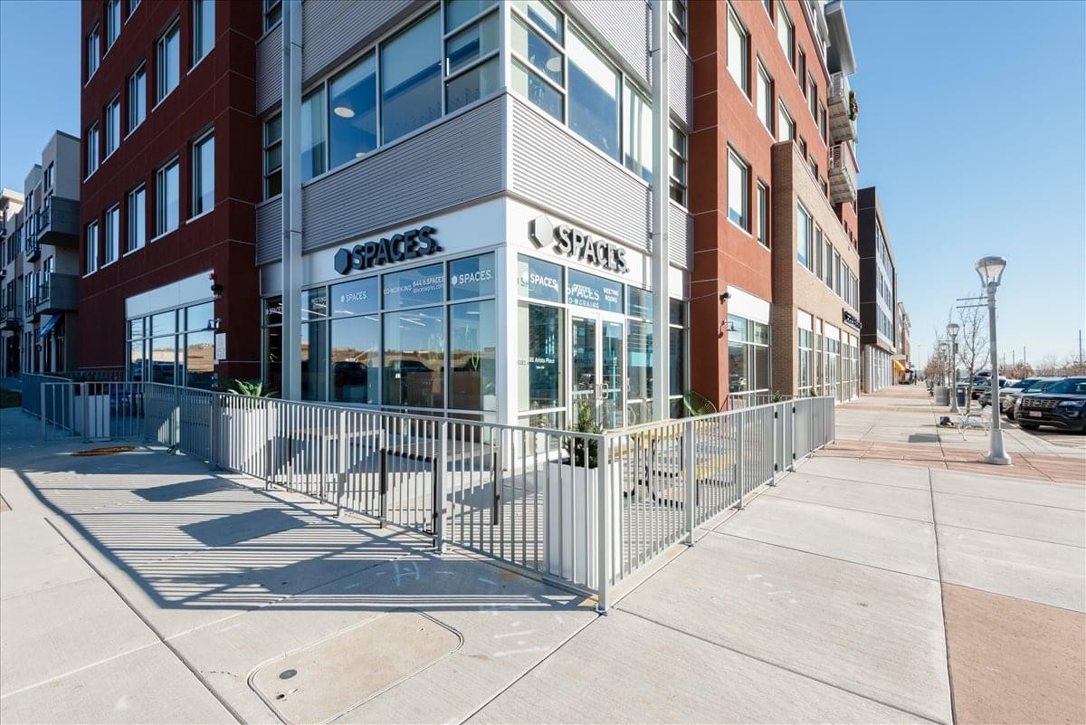 Exterior corner view of the modern brick and glass building at 8181 Arista Place, Suites 100, 200 & 500.