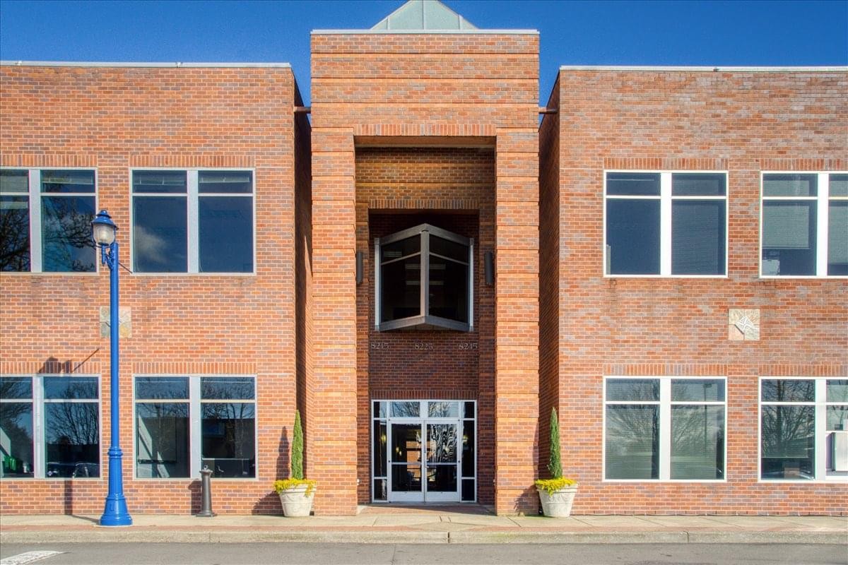 Brick facade and entrance of 8215 SW Tualatin Sherwood Road, Suite 200.